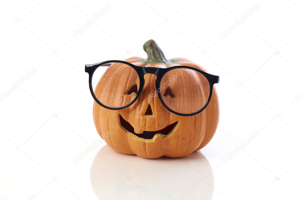 Carved smiling pumpkin Jack-o'-lantern with spectacle