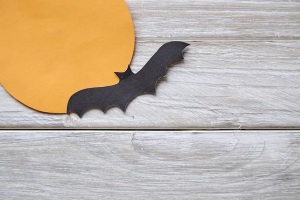 Halloween holiday moon paper with paper bats on the old white wood table background