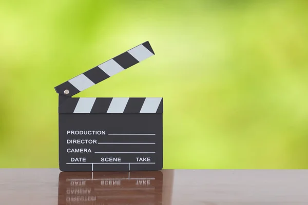 Clapper board or slate film concept On wooden table, for production of film Concept