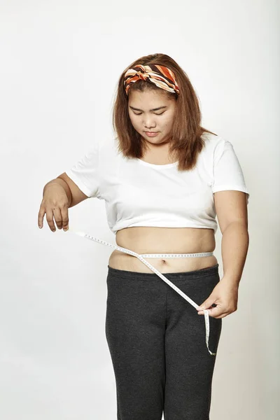 Fat young woman asian with measure tape studio on white background.