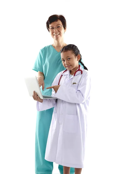 Mulher Velha Menina Trajes Médico Conversando Enquanto Segurando Laptop Isolado — Fotografia de Stock