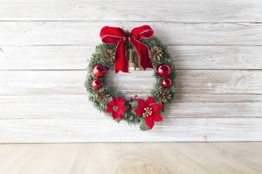 Çam kozalakları ve eski ahşap masa bir beyaz duvar ahşap arka plan, metin, düz yatıyordu için yer üzerinde kırmızı meyveler ile Noel çelenk görüntülemek yukarıdan