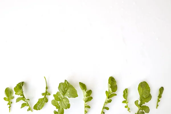 Fresh Green Rocket leaves salad leaf on white