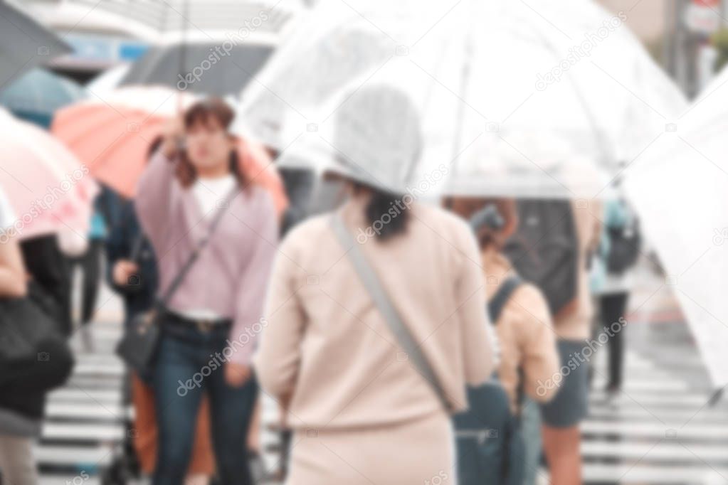 Blurred People holding umbrellas the street in the city, Tokyo in Japan