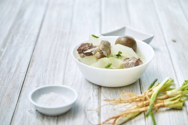 Ünlü ev yapımı taze turşu limon çorbası domuz eti ve kendi mesaj, doğal ışık yazmak için boş alan ile beyaz ahşap masa kış kavun