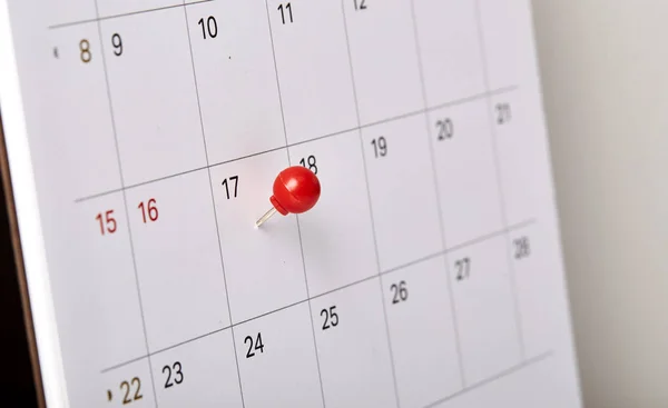 Red thumbtack a date 17th on calendar or planner. Tax Day 2018 takes place on April 17. selective focus
