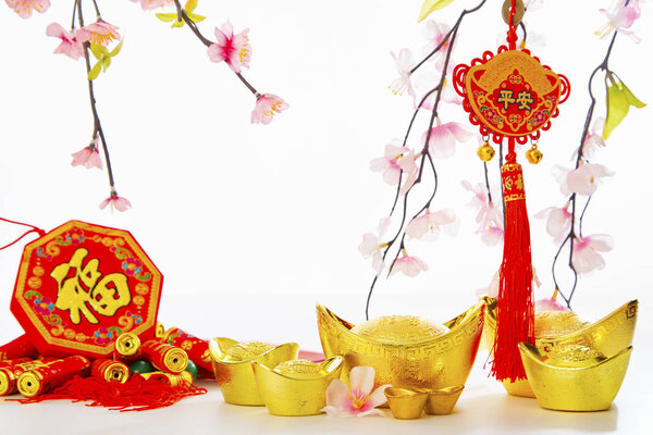 Chinese New Year Decorations Traditional Handicraft gold ingot and firecrackers and Plum Tree on empty white background for business promote and Chinese alphabet meaning of rich and goodluck.