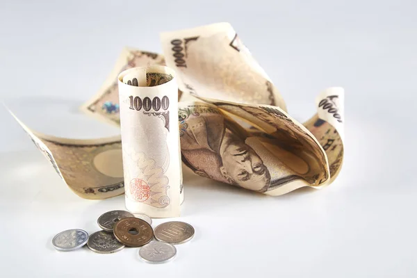 Japanese yen banknotes and Japanese yen coin on white background