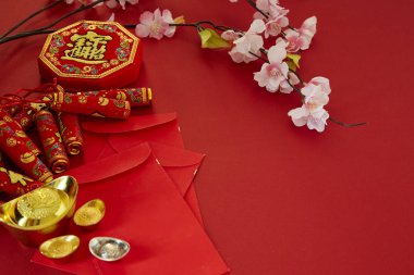 Çin yeni yılı 2019 festival decorations.firecrackers,gold külçe, kırmızı paket, Erik çiçeği, kırmızı zemin üzerine. Üstten görünüm aksesuarları. Çeviri: Fu iyi servet, bahar anlam Chun anlamı.