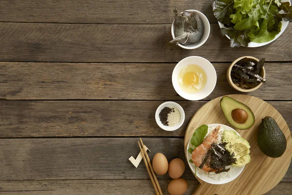 Avocado Hawaii food poke bowl Composition of kitchen devices on wooden table, Healthy Food Concepts, free copy space, flat lay food
