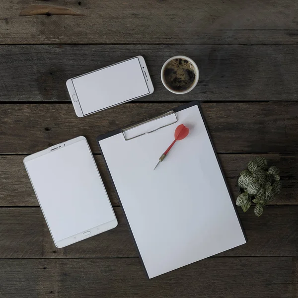 Top view of wood office desk table with supplies and blank a4 paper in the middle. Top view, flay layout., office desk with blank places to your concept