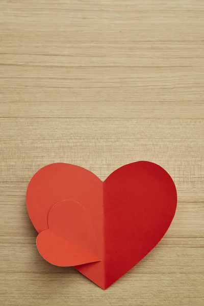 Valentine\'s day red paper heart on abstract wooden background with for text love and young happy joyful, paper cut red heart, love Invitation card