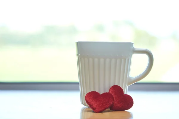 Valentine\'s day concept with hearts and cup over green background - Image