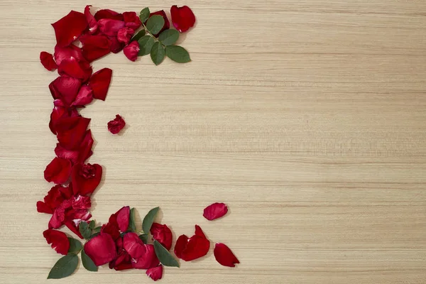 frame red roses petals on wooden love, romance, valentines day and holidays concept