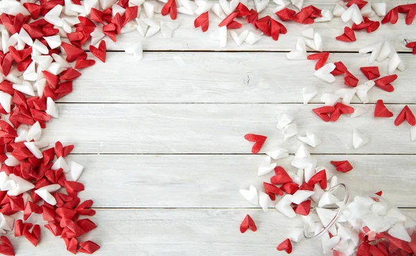 Valentine\'s Day symbolizing love Red and white origami hearts in Glass bottle white wooden table background, Empty space for simple design