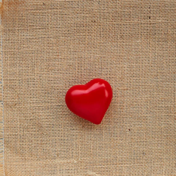 Red ball heart love on the sackcloth background, Romantic Valentines Day or Christmas concept. Red heart made of wool yarn. Festive photo with place for text, copyspace.with love