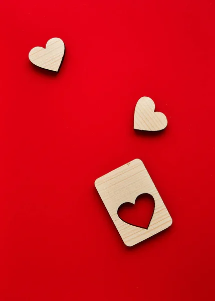 Jigsaw Puzzle form the Wooden Love hearts on texture red paper background. Valentines day card concept