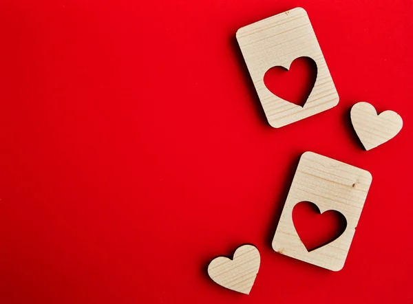 Jigsaw Puzzle form the Wooden Love hearts on texture red paper background. Valentines day card concept