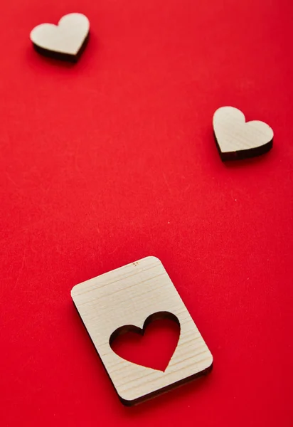 Jigsaw Puzzle form the Wooden Love hearts on texture red paper background. Valentines day card concept