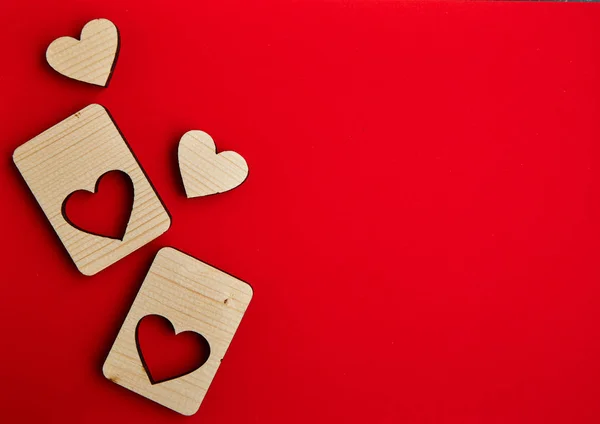 Jigsaw Puzzle form the Wooden Love hearts on texture red paper background. Valentines day card concept