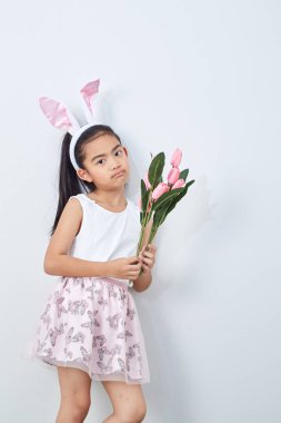 Pembe lale duvar parlak gri arka plan tutan paskalya tavşanı kulakları ile Sevimli küçük kız, Konsept büyük satış bahar arka plan