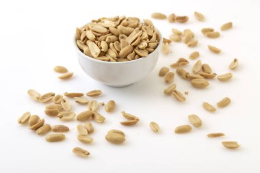 Roasted peanuts and salt in a bowl clipart