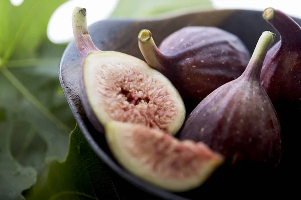 figs in a a bowl with fig leaf