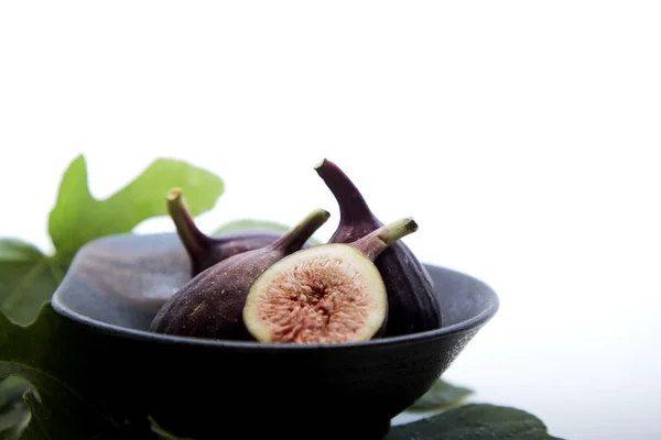 Higos en un tazón con hoja de higo — Foto de Stock