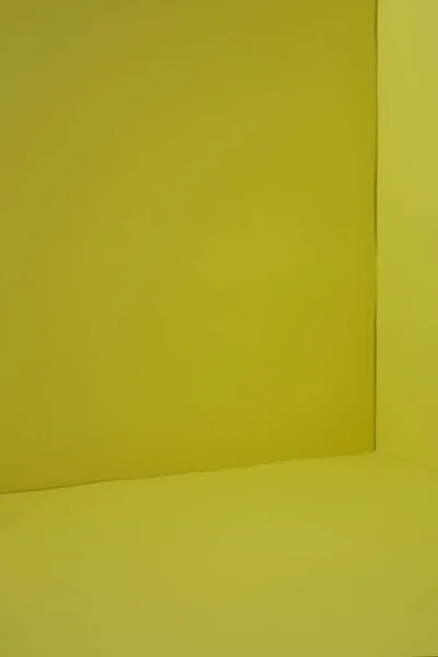 Empty corner yellow room with light from window