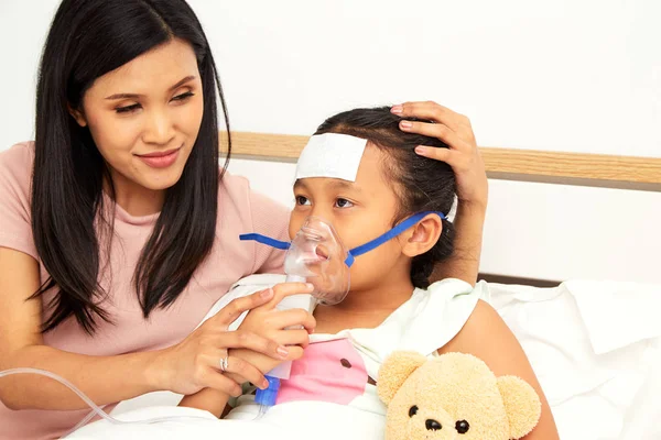 Junge asiatische Mutter Kinderkrankenpflege — Stockfoto