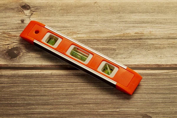 New spirit level on wood background — Stock Image New spirit level on wood background Royalty Free Stock Images