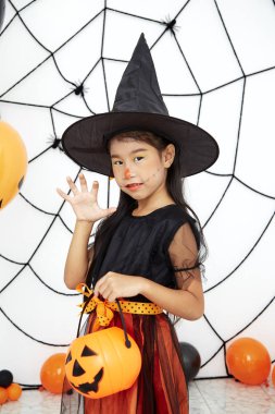 Bir balkabağı ile Mutlu Cadılar Bayramı küçük cadı