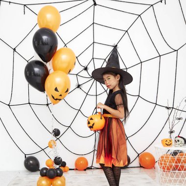 Bir balkabağı ile Mutlu Cadılar Bayramı küçük cadı