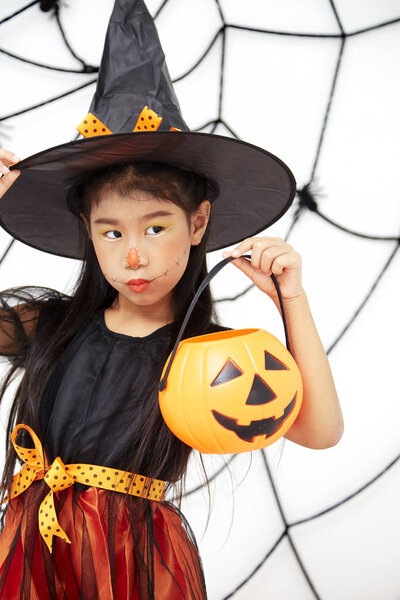 Happy Halloween little witch with a pumpkin
