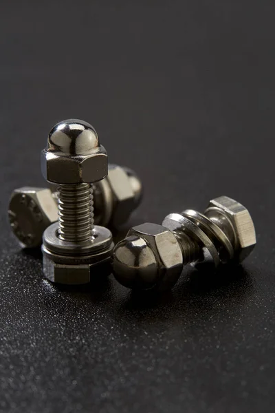 Bolt and nut on black background — Stock Photo, Image