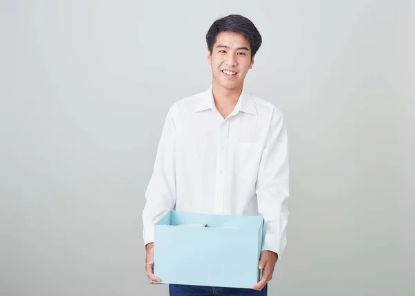 Young asian businessman holding a box — Stock Photo, Image