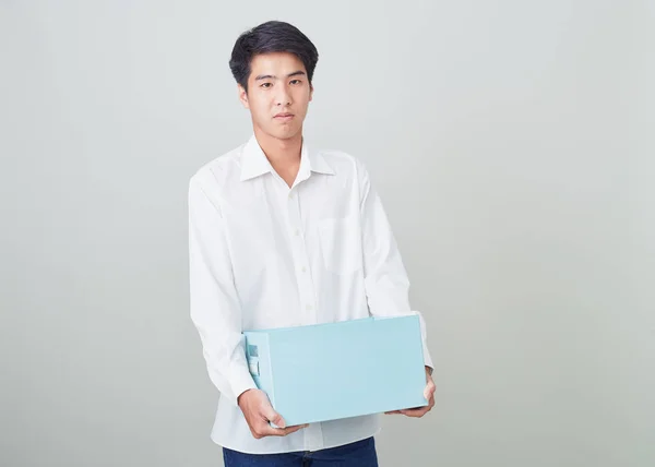 Young asian businessman holding a box — Stock Photo, Image