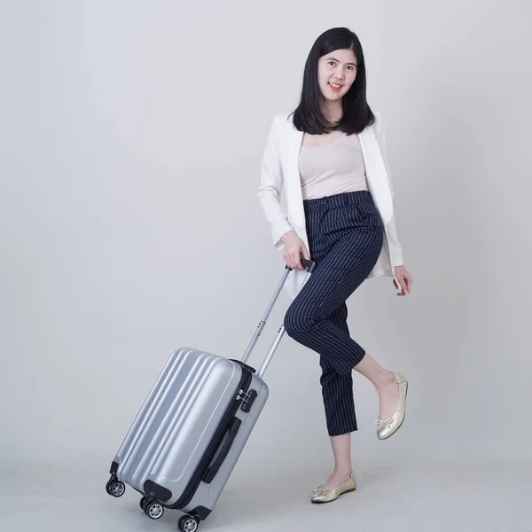 Young Asian woman tourist with luggage to travel