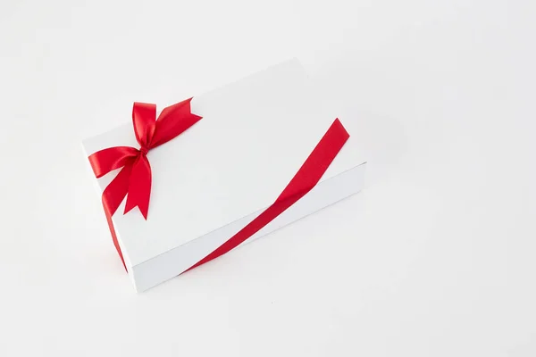 Red ribbon gift box on the white Stock Picture