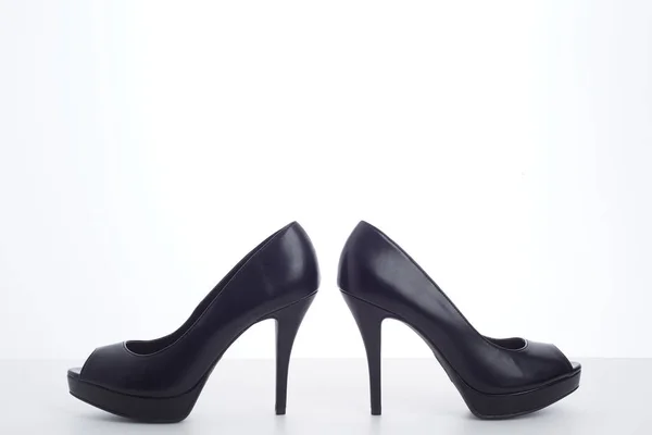 Black high-heeled shoes on white — Stock Photo, Image