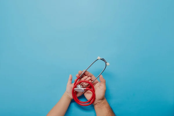 Adult Child Hands Holding Red Stethoscope Blue Background Copy Space — Stock Photo, Image