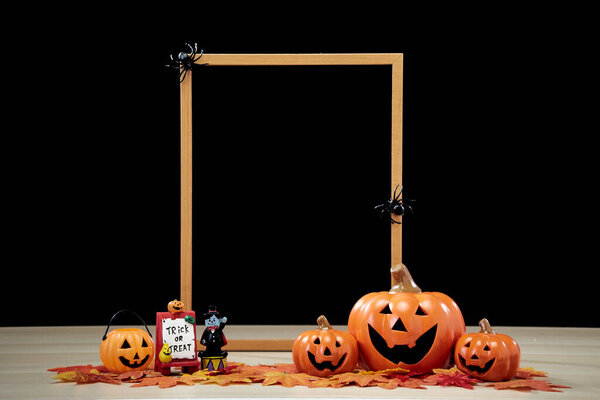 Frame and Jack O Lantern Halloween festival decoration pumpkin with witches hat on wooden table with dark background copy space for text