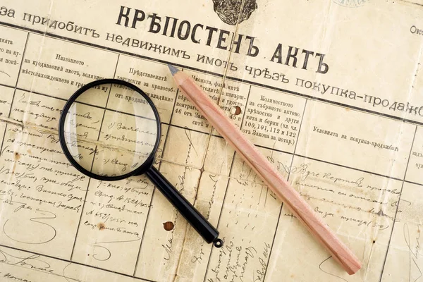 old deed property, magnifying glass and pencil, selective focus