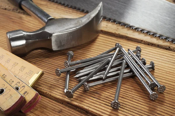 Handsaw Hammer Nails Folding Ruler Wooden Background — Stock Photo, Image