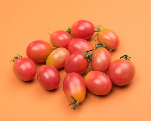 Cherry tomatoes on a colored background