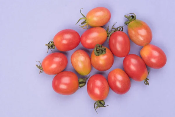 Cherry tomatoes on a colored background