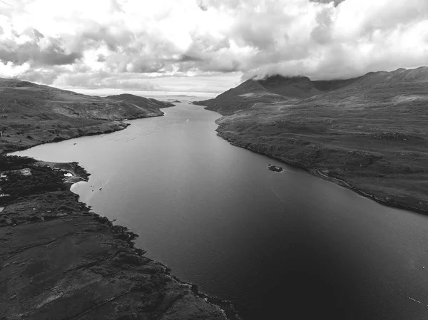 Aerial birds eye Black and White scenic view from Connemara National Park in County Galway, Ireland. Beautiful Irish rural nature countryside landscape with mountains in the distance.