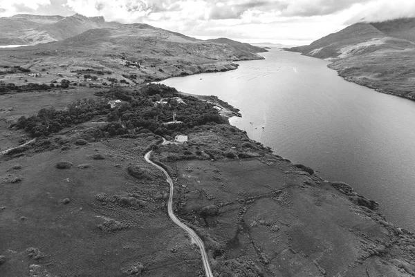 Aerial birds eye Black and White scenic view from Connemara National Park in County Galway, Ireland. Beautiful Irish rural nature countryside landscape with mountains in the distance.