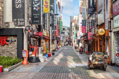Busan, South Korea - October 7, 2017: Morning view of colorful signboards on deserted street of Busan. Gwangbokro Cultural and Fashion Street. Gwangbokro is a popular tourist destination of Asia. clipart