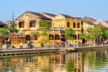 Hoi bir (Hoian), Vietnam - 11 Nisan 2018: geleneksel sarı mavi gökyüzü arka planda Hoi An antik kenti üzerine inşa görünümünü şaşırtıcı. Prş Bon nehir set yürüyüş turist.